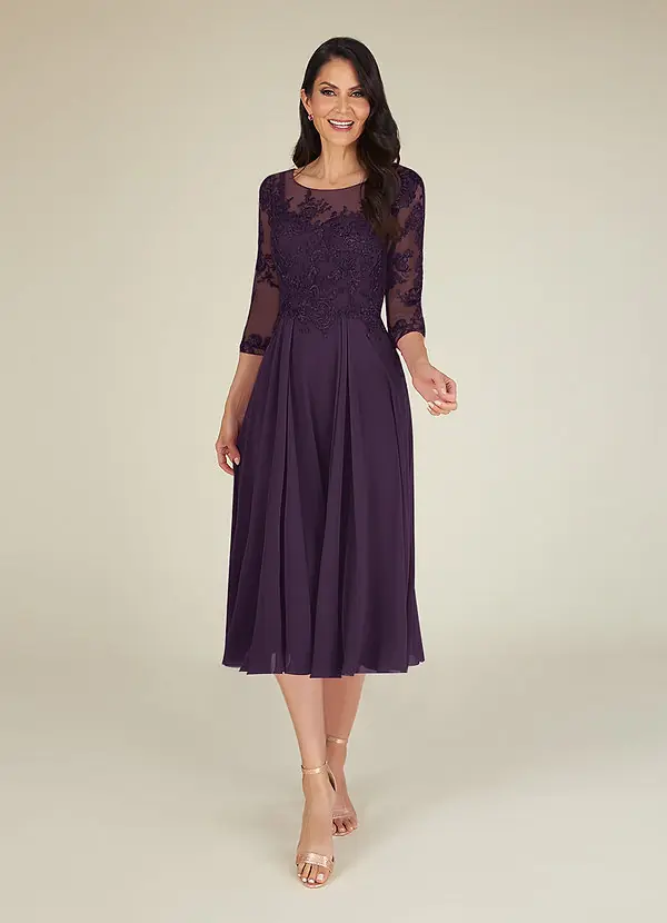 A woman wearing a plum lace and chiffon tea length dress with three quarter sleeves for a winter wedding