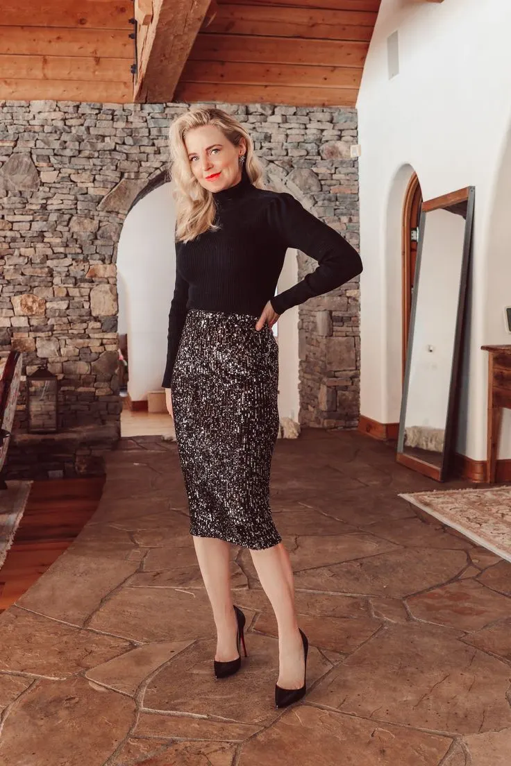 Woman over 40 wearing a black turtleneck with a black sequin pencil skirt and heels