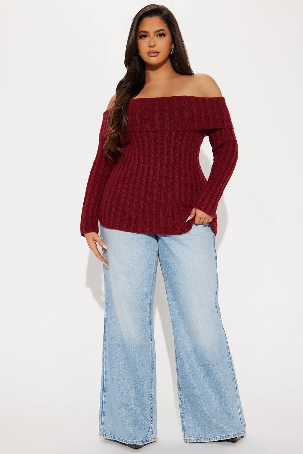 Midsize woman styling a burgundy off shoulder sweater with wide leg jeans for a casual date night